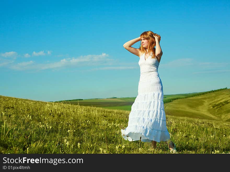 Beautiful girl wearing a white dress outdoor in summertime. Beautiful girl wearing a white dress outdoor in summertime