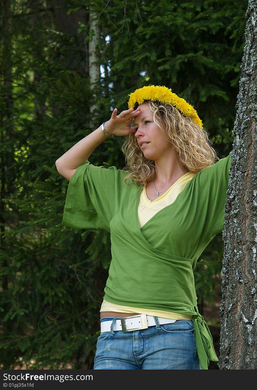 Curly girl with dandelion chain on head