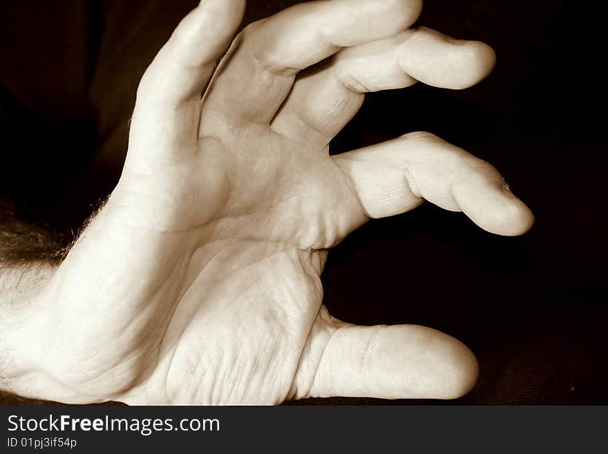 Hand of young man with black background