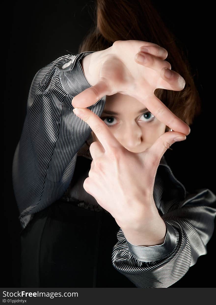 Young girl making frame with her fingers