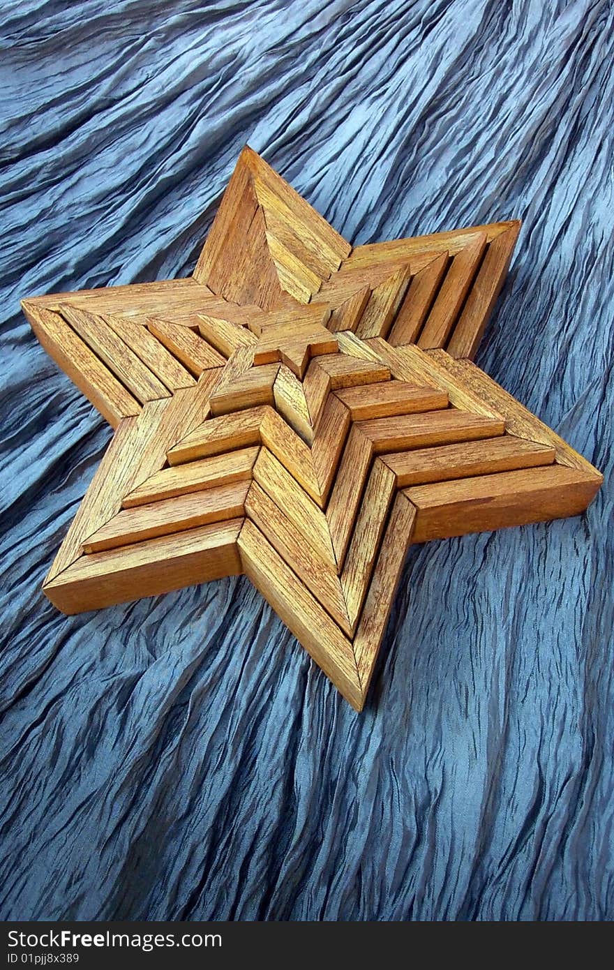 Handcrafted wooden stars on crinkled background. Handcrafted wooden stars on crinkled background