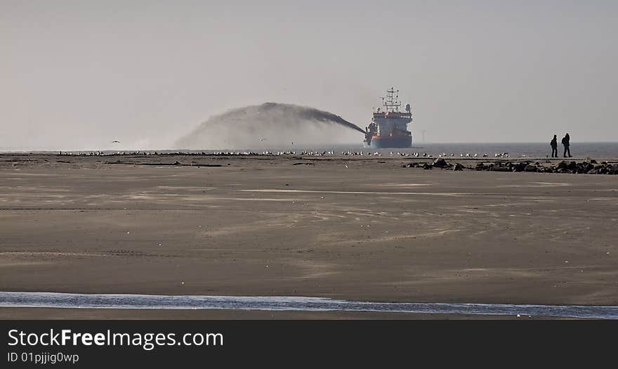 A Trailing suction hopper Dredger at Work on the dutch coast. A Trailing suction hopper Dredger at Work on the dutch coast