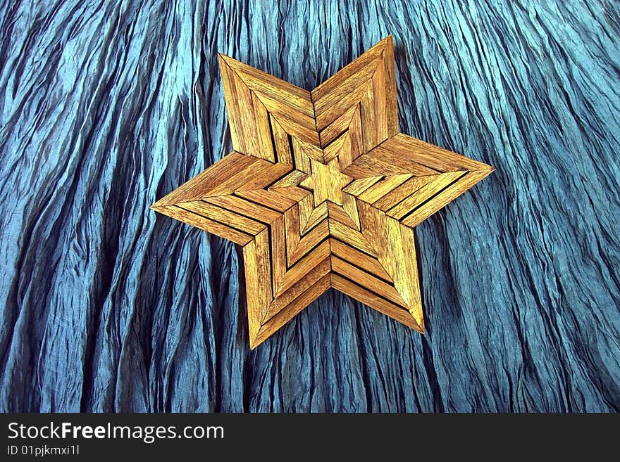 Handcrafted wooden stars on crinkled background. Handcrafted wooden stars on crinkled background