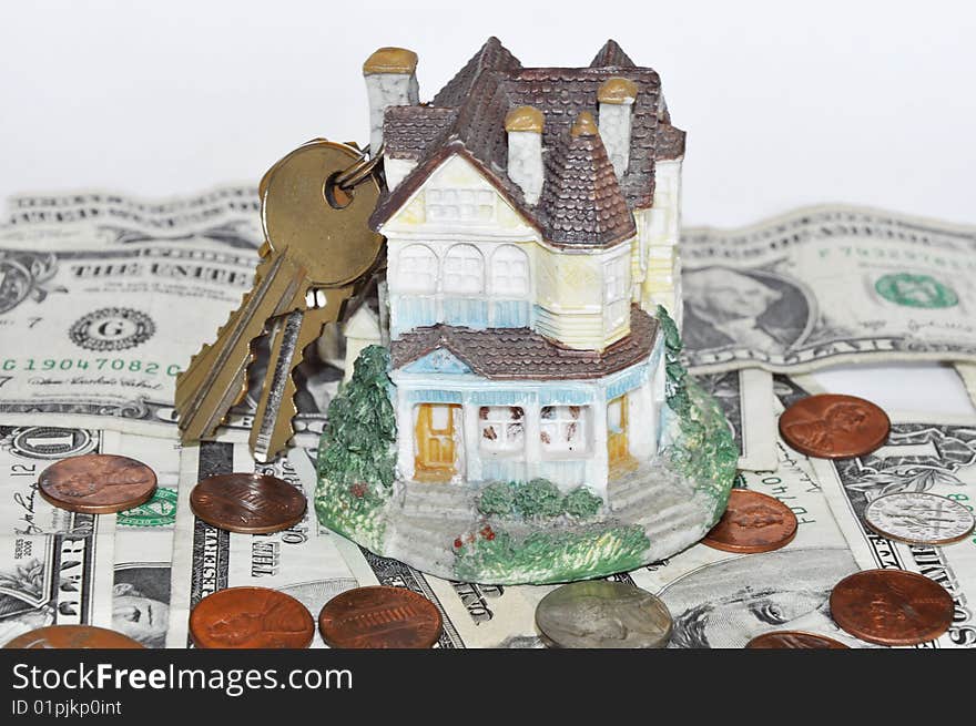 House with keys on dollar bills background