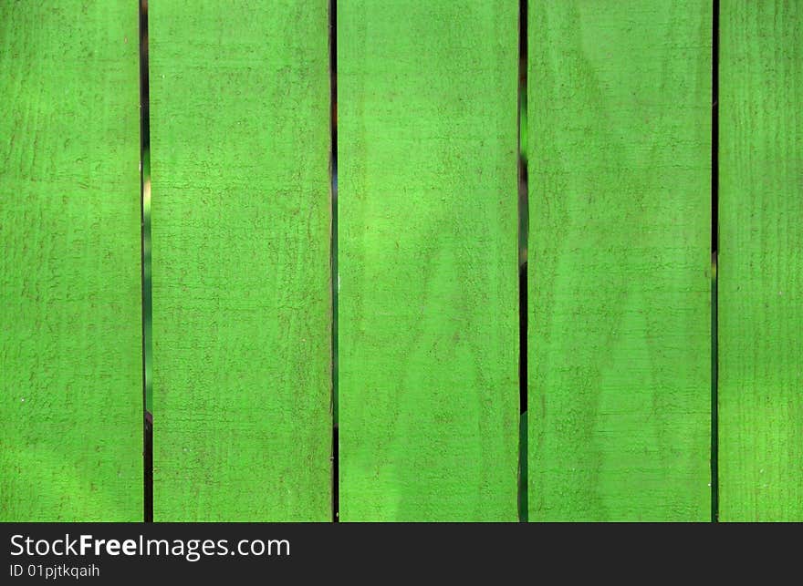 A wooden fence painted bright green. A wooden fence painted bright green.