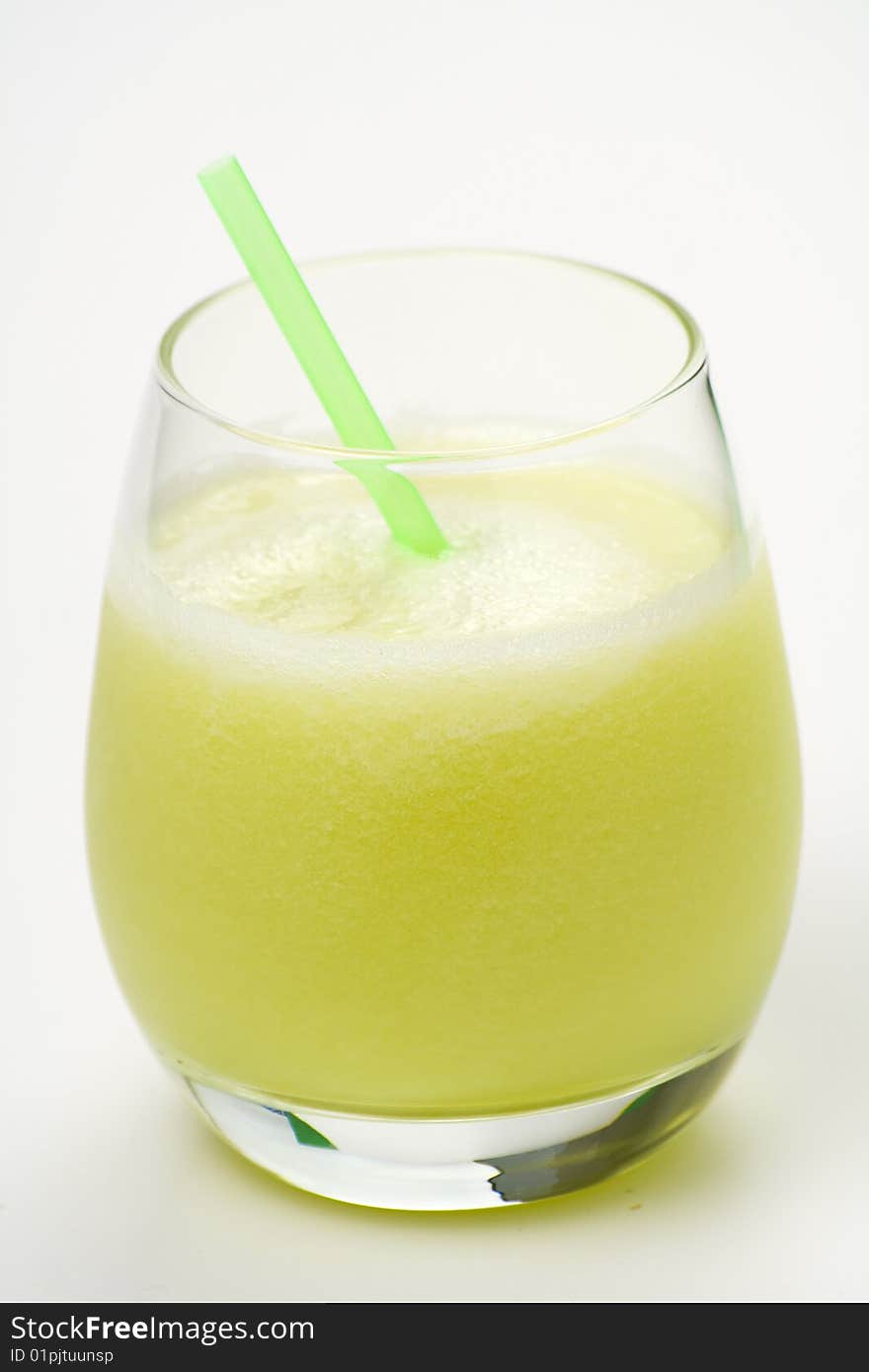 A delicious melon milkshake isolated over white. A delicious melon milkshake isolated over white