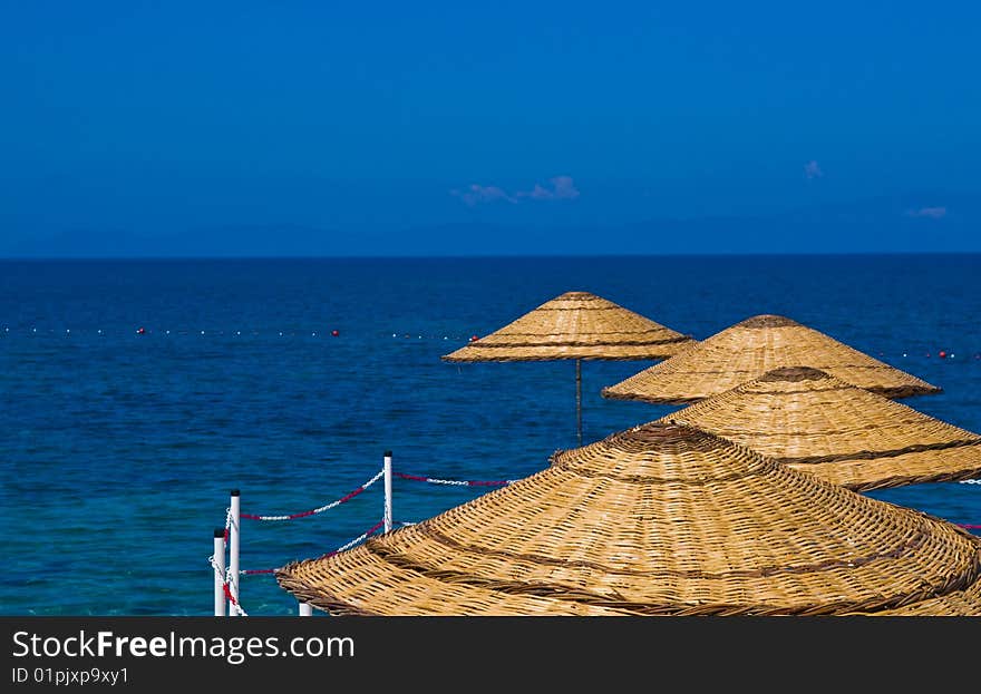 Sunshades in Turkish resort in the Aegean sea