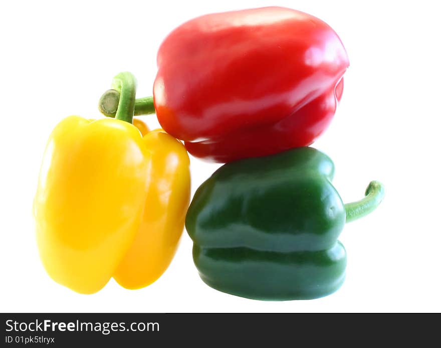 Red, yellow and green pepper, on a white background.