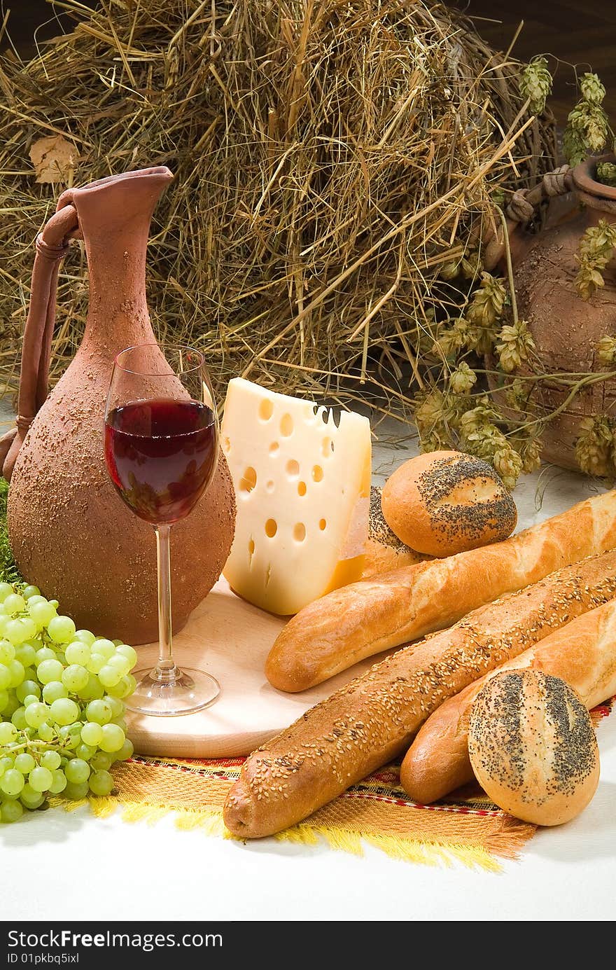 Bread with grape, wine and ceramic pot