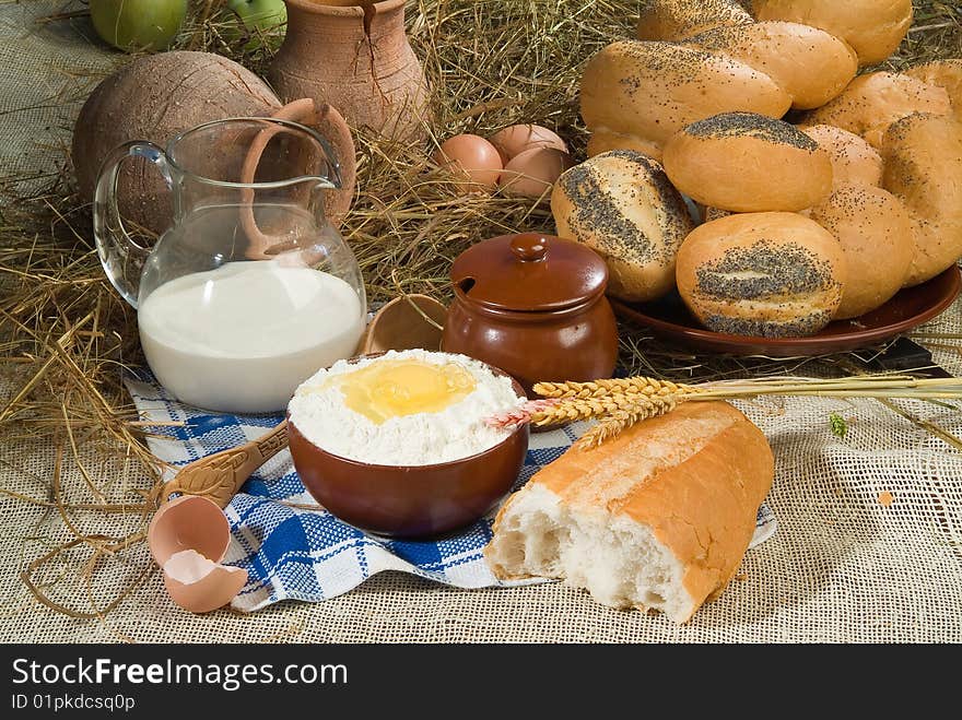 Bread, milk and ceramic on canvas tablecloth. Bread, milk and ceramic on canvas tablecloth