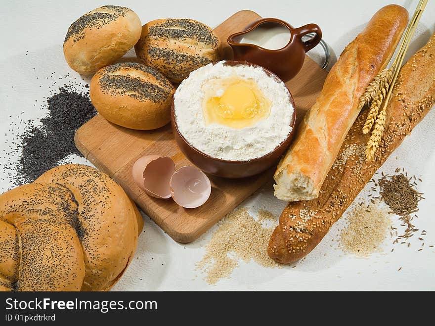 Bread, milk, ceramic on canvas tablecloth