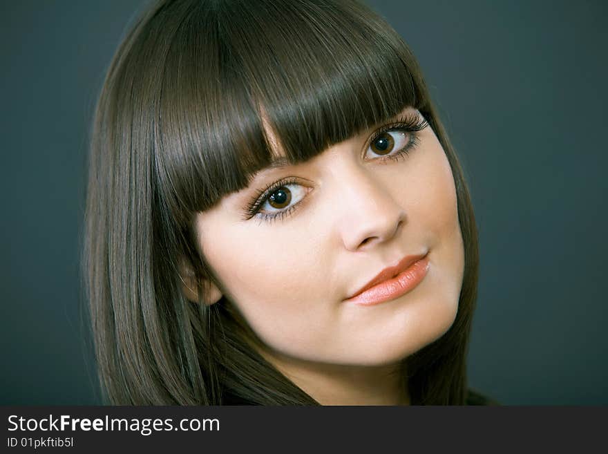 Close-up portrait of a beautiful woman on a black background