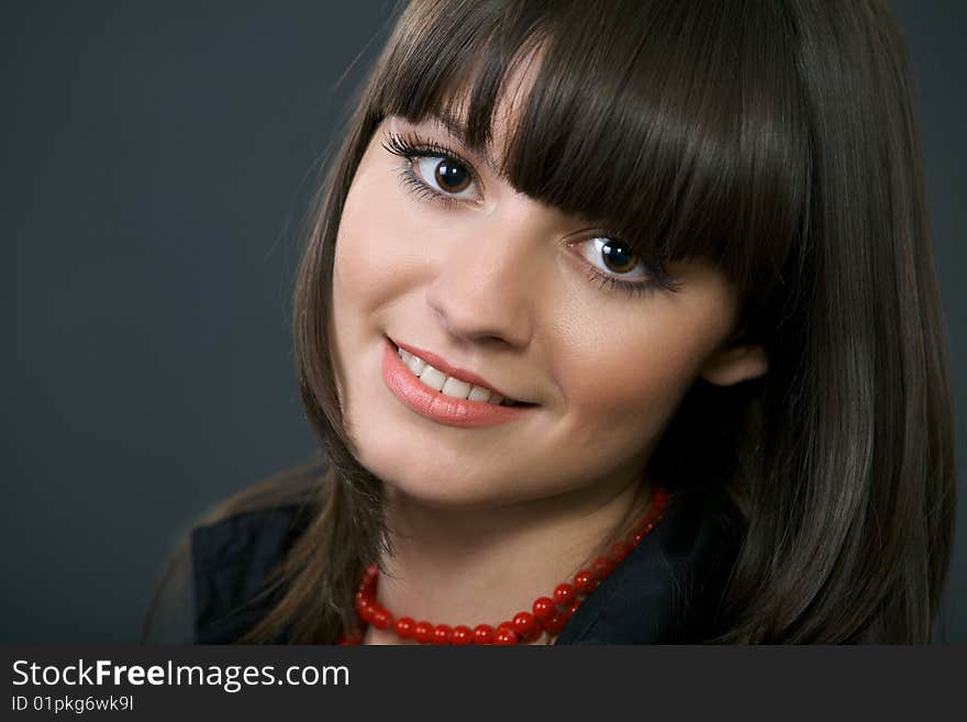 Close-up portrait of a beautiful woman on a black background