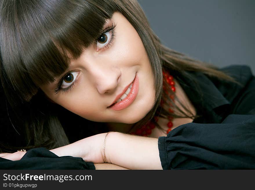 Close-up portrait of a beautiful woman on a black background