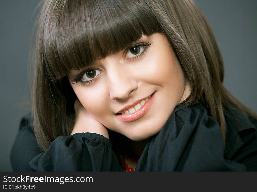 Close-up portrait of a beautiful woman on a black background