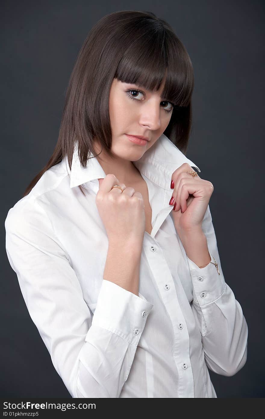 Pretty fashion model posing on a dark background