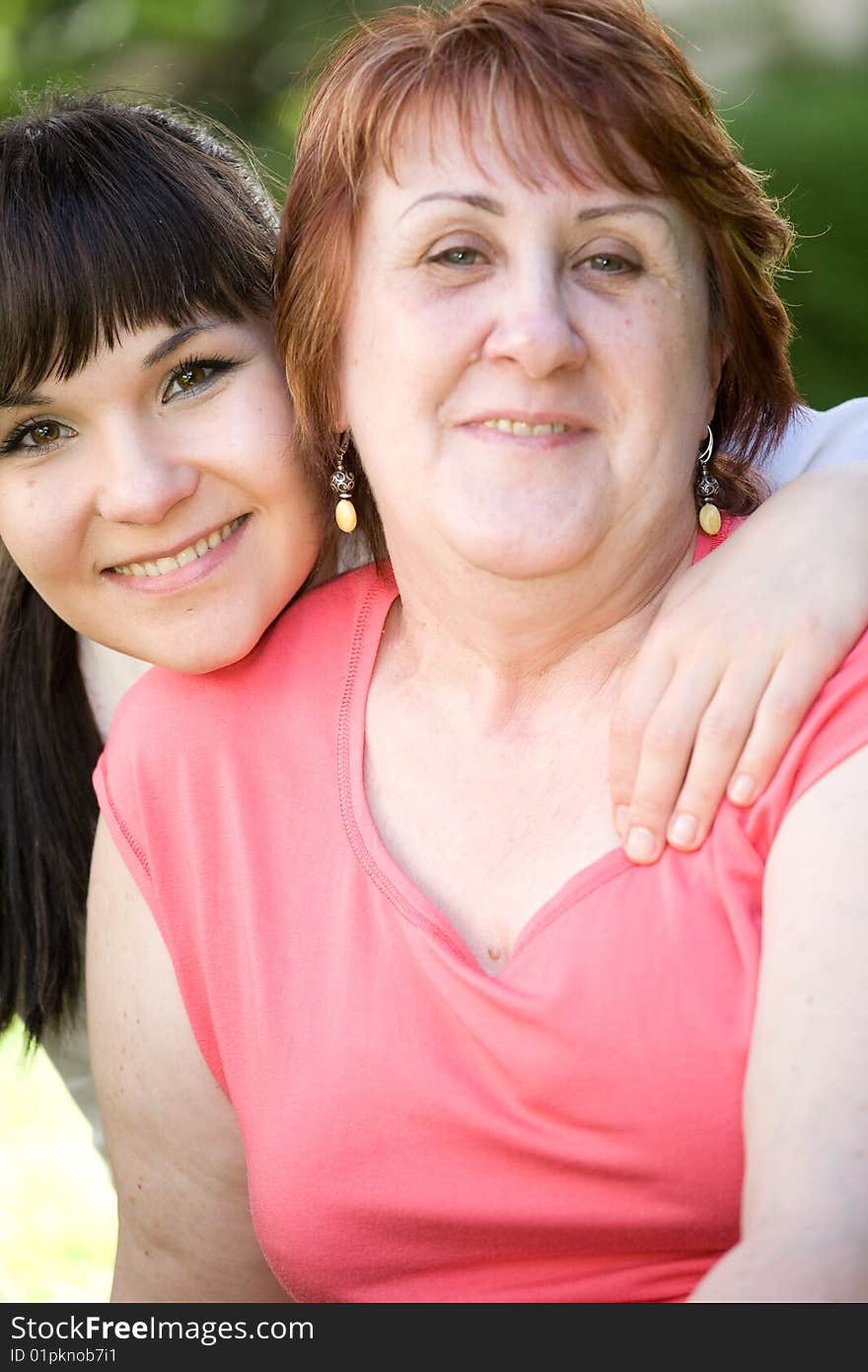 Happy mother and daughter together in garden