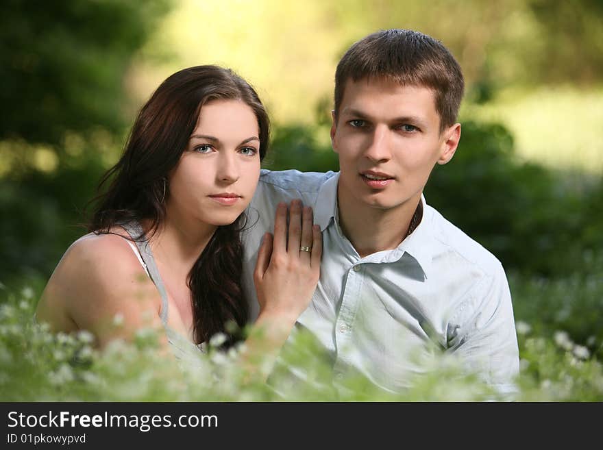 Man and woman sitting on the grass. Man and woman sitting on the grass.