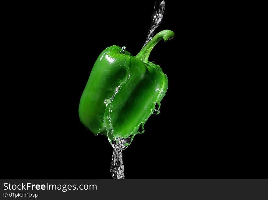 Green pepper in water stream