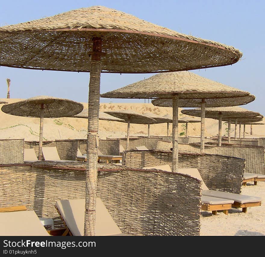 egyptian beach view with chairs and parasol of twisted cane