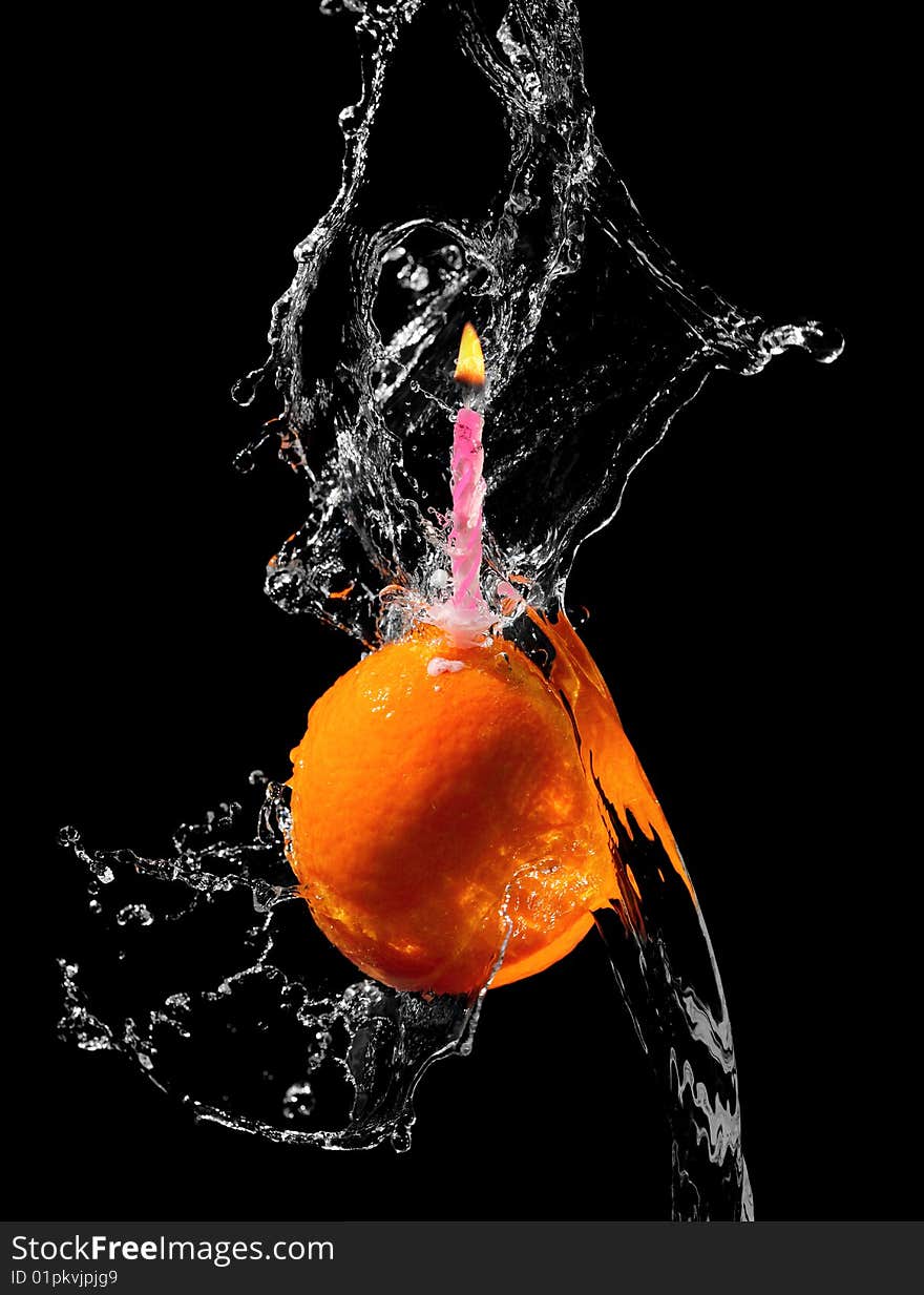 Orange with candle in water splash