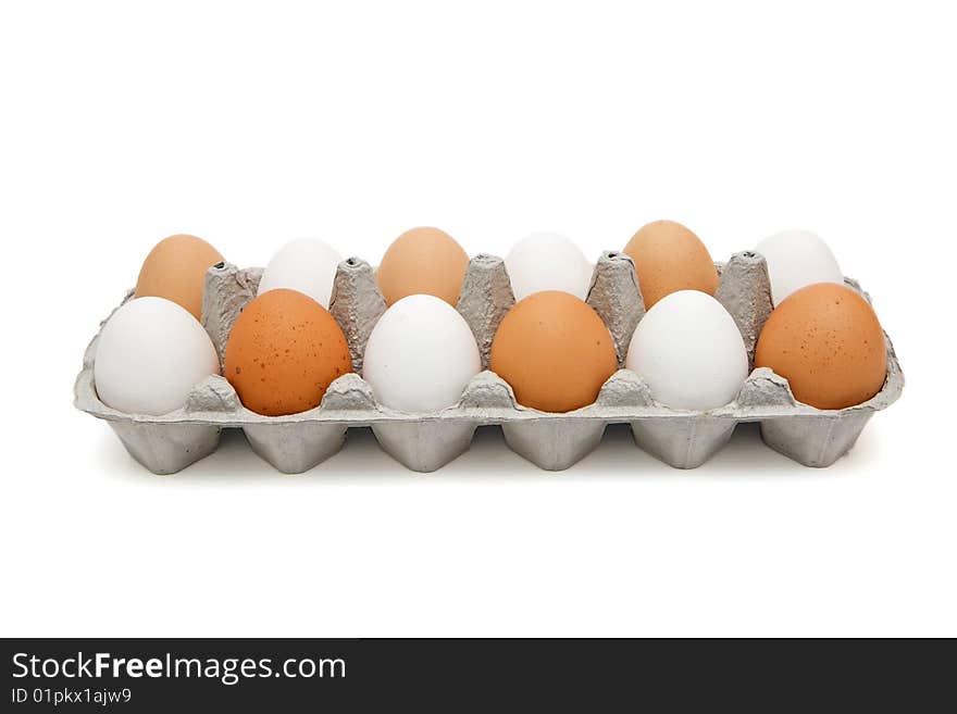 White and brown eggs in paper box isolated