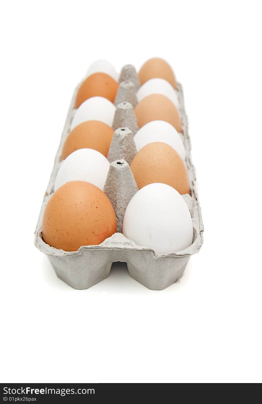 White and brown eggs in paper box isolated