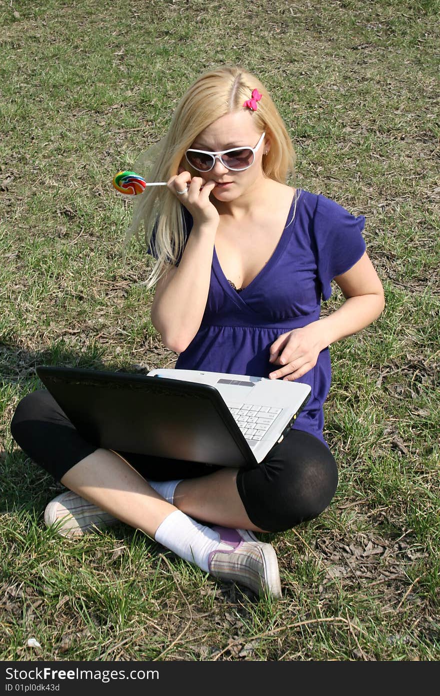 Busy student working on laptop outdoors