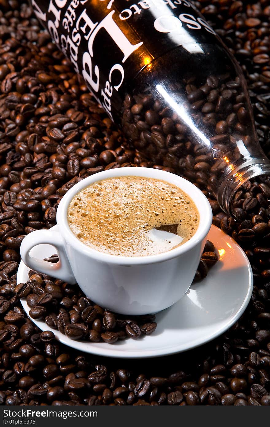 White cup, beans and glass bottle. White cup, beans and glass bottle