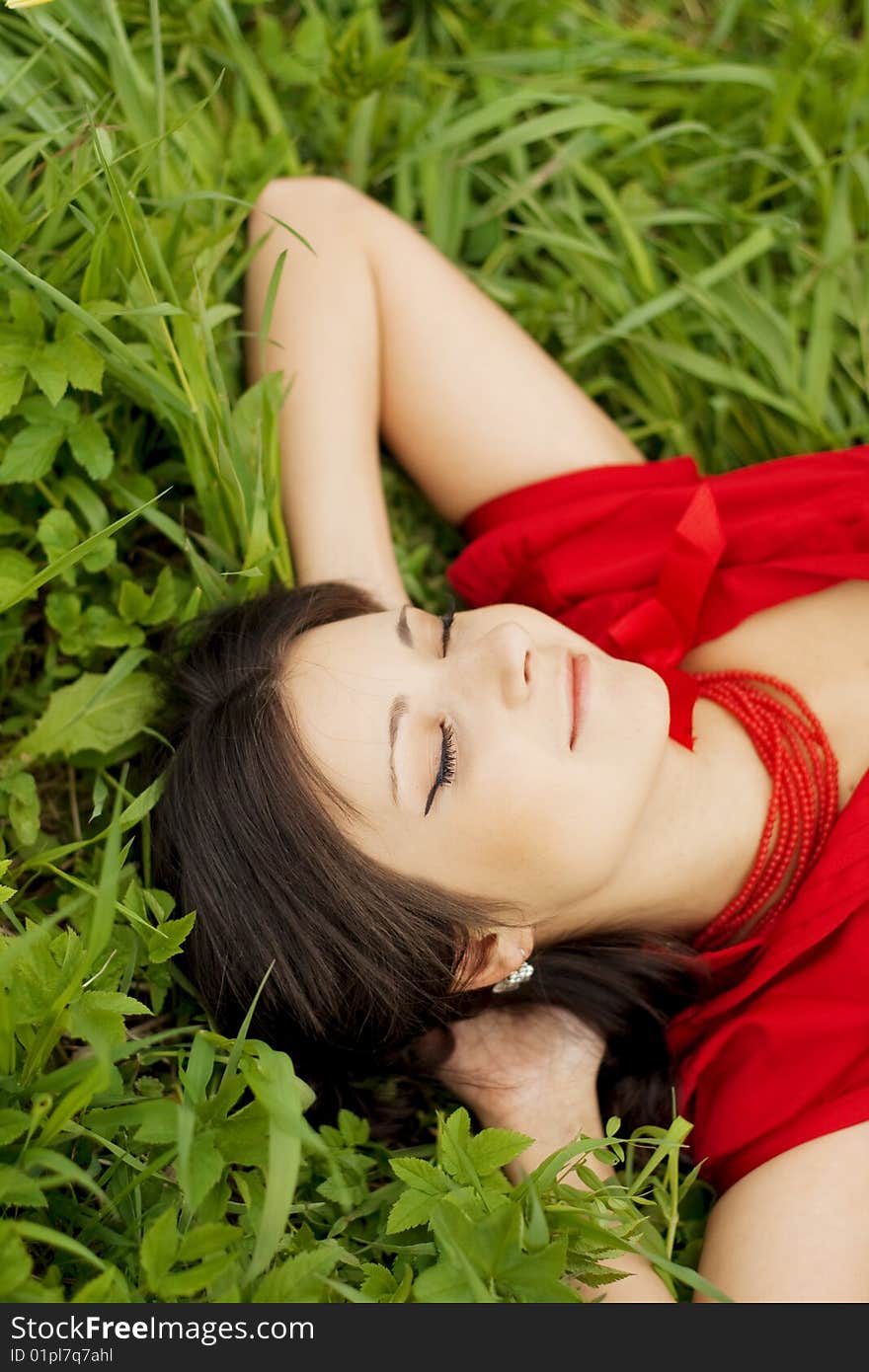 Beautiful girl lying on the grass