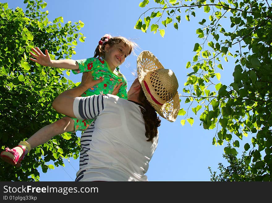 Mum with the daughter against the blue sky. Mum with the daughter against the blue sky