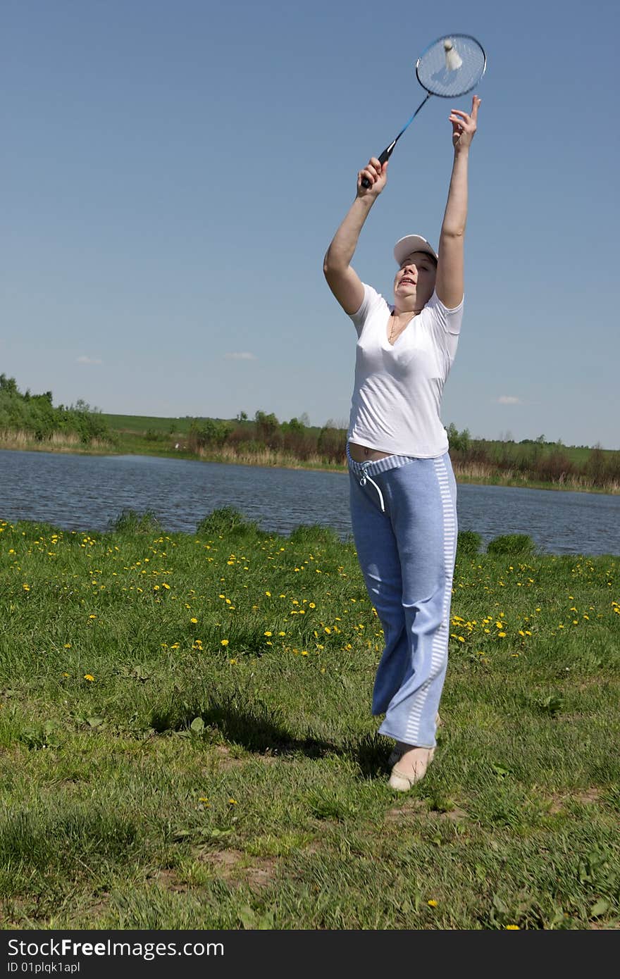 Woman plays in badminton