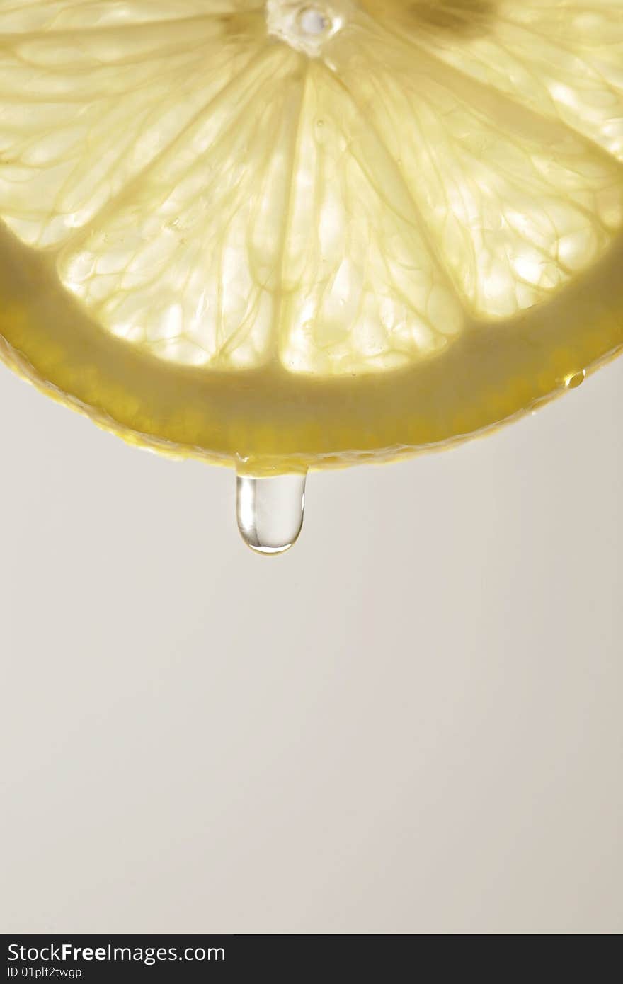 Detail of lemon slice with juice drop