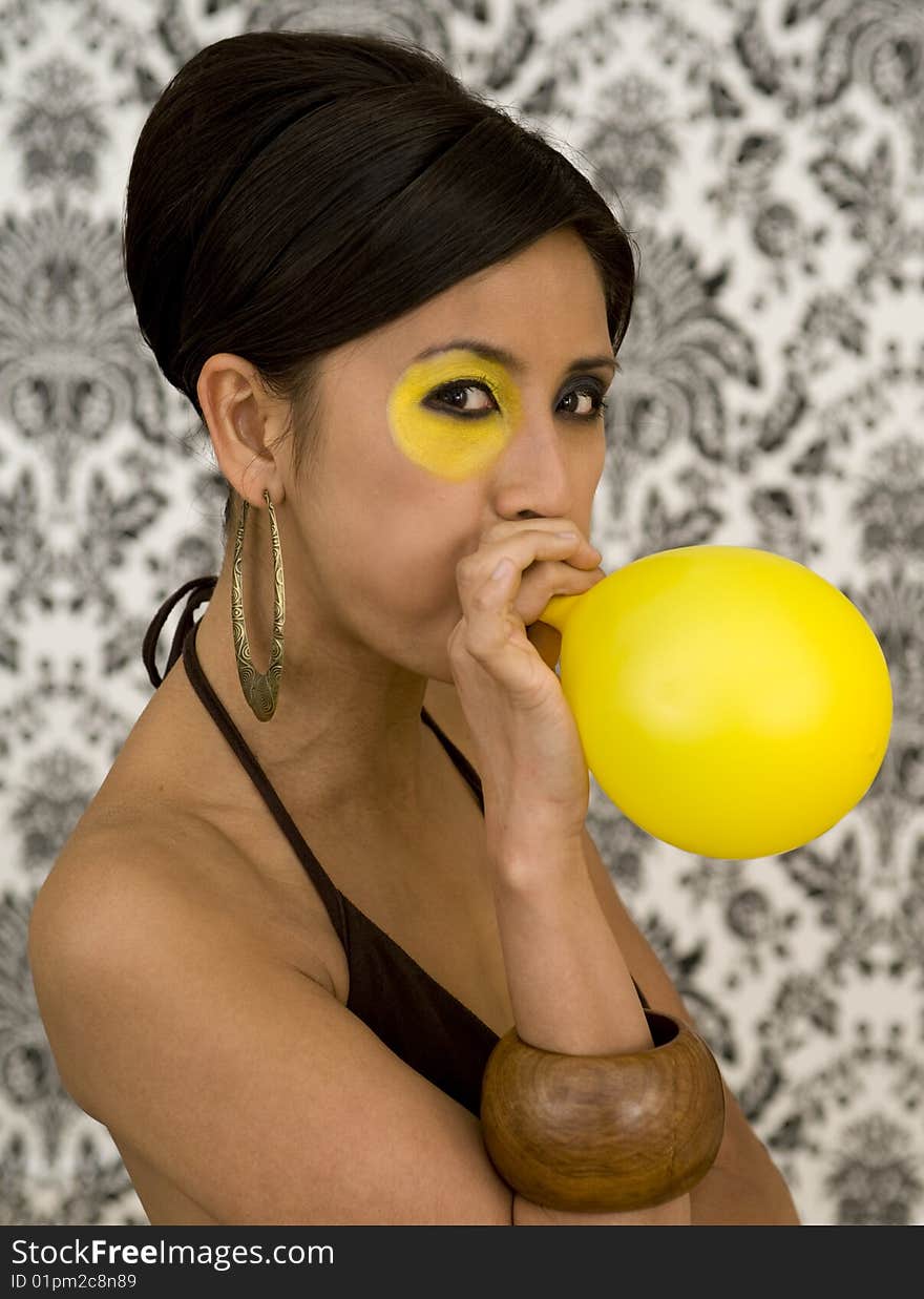 Beautiful asian model with funky make-up blow balloon. Beautiful asian model with funky make-up blow balloon