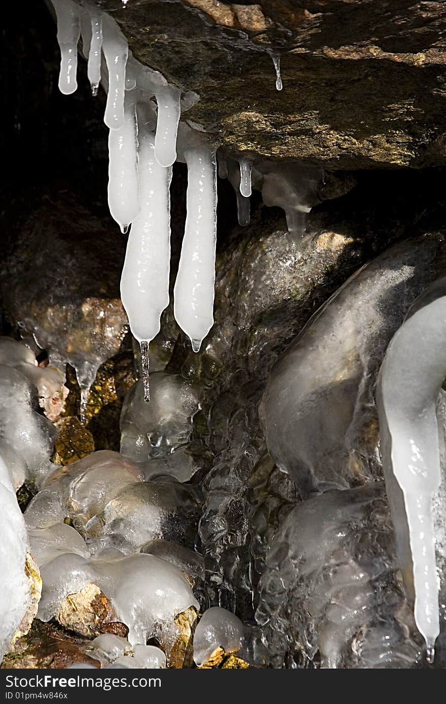 Ice stalagtites under the rock