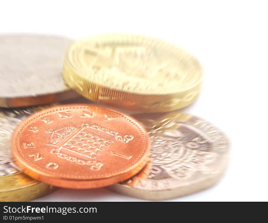 Close-up of UK coins on white with zoom effect