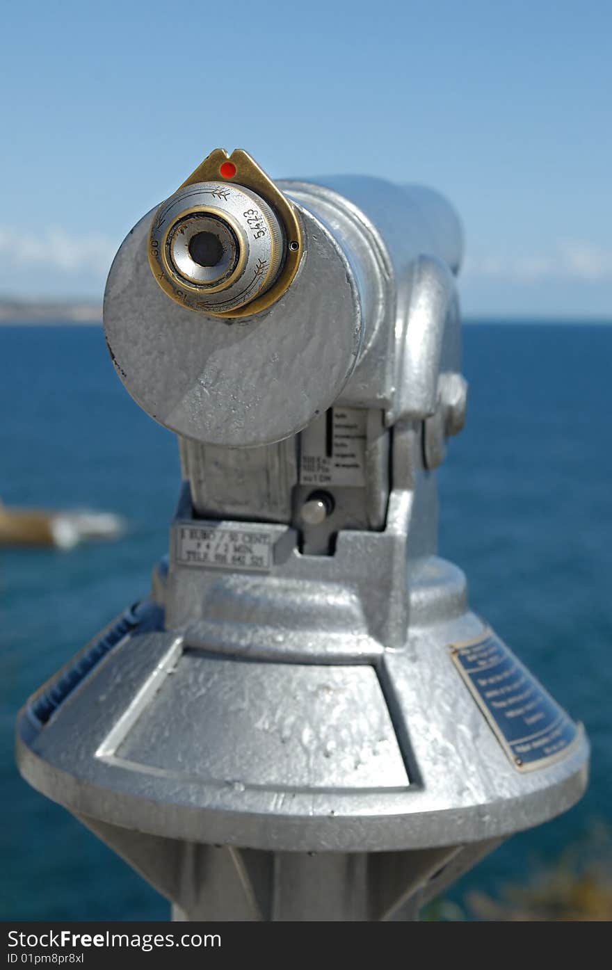 A silver binocular at the coast