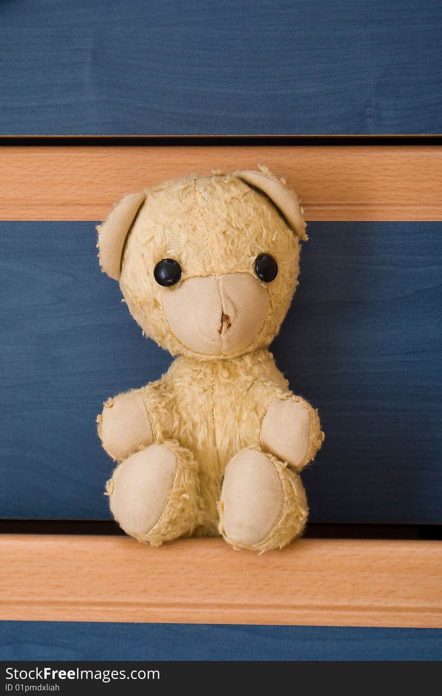 30years old teddy bear sitting on drawer