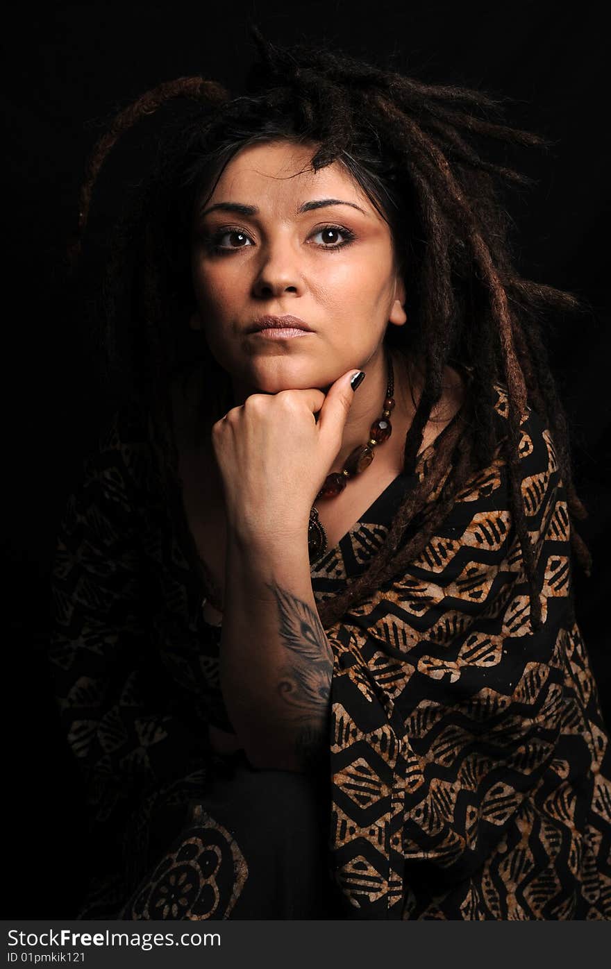 Beautiful woman with dreadlocks over black