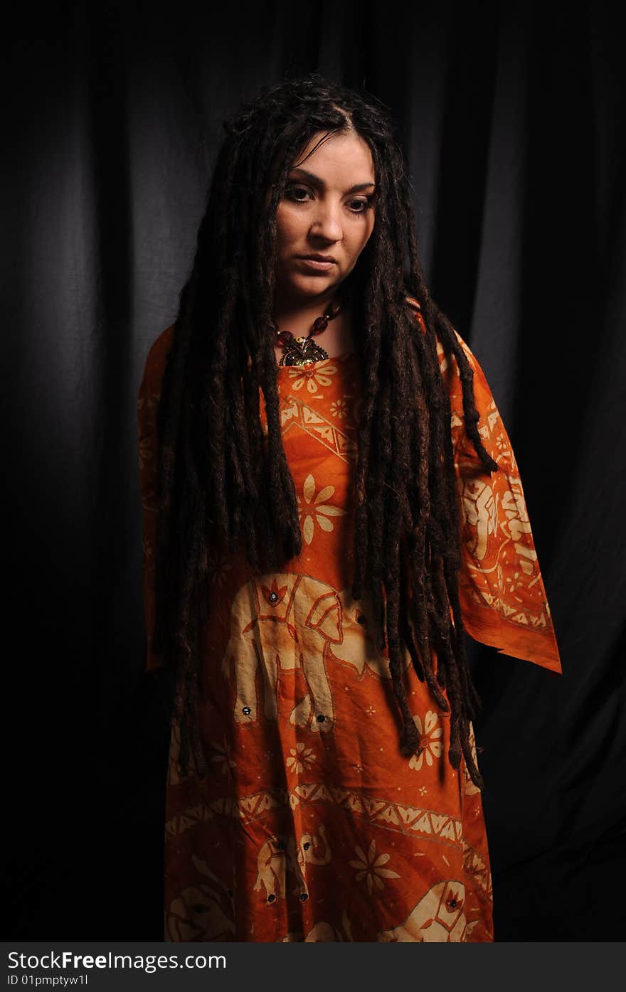 Beautiful woman with dreadlocks over black