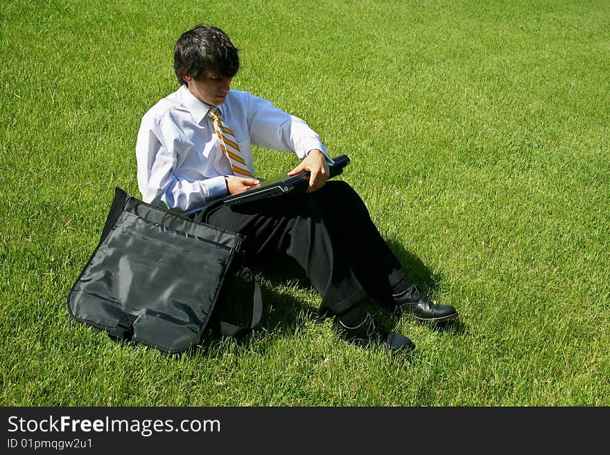 Business Man Sitting in Grass