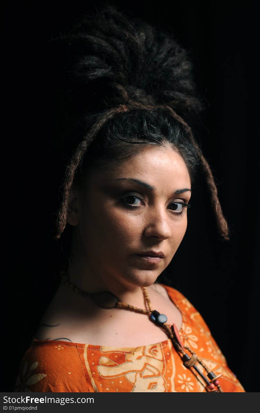 Beautiful woman with dreadlocks over black