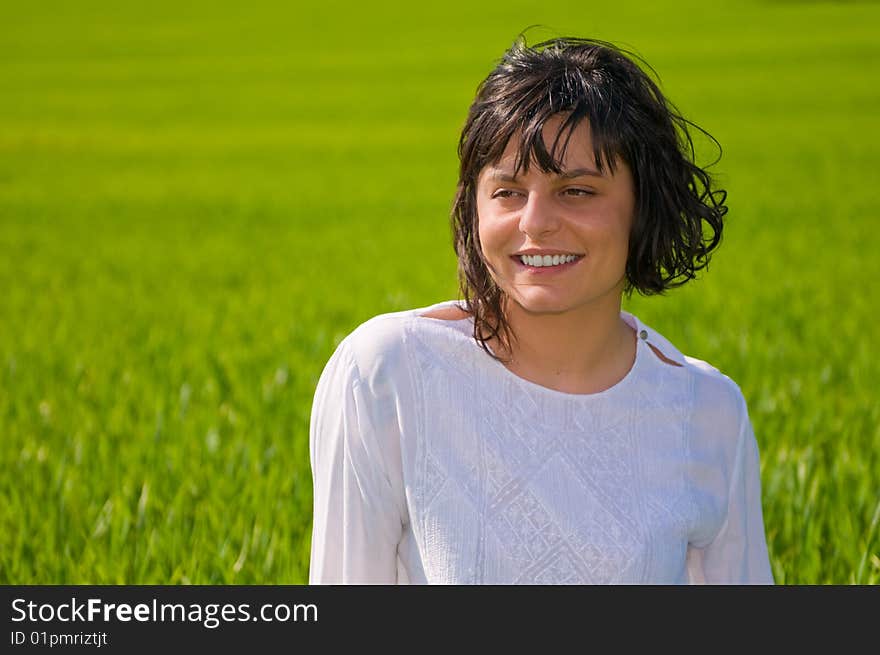 Closeup portrait of a young woman on green