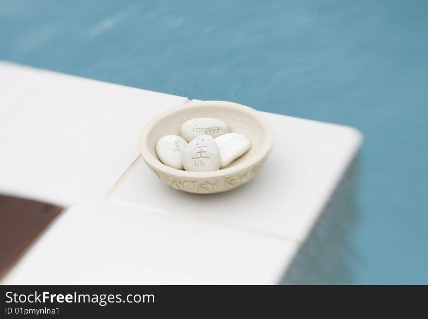 Message stones in a bowl. Words of love and friendship are engraved on stones.