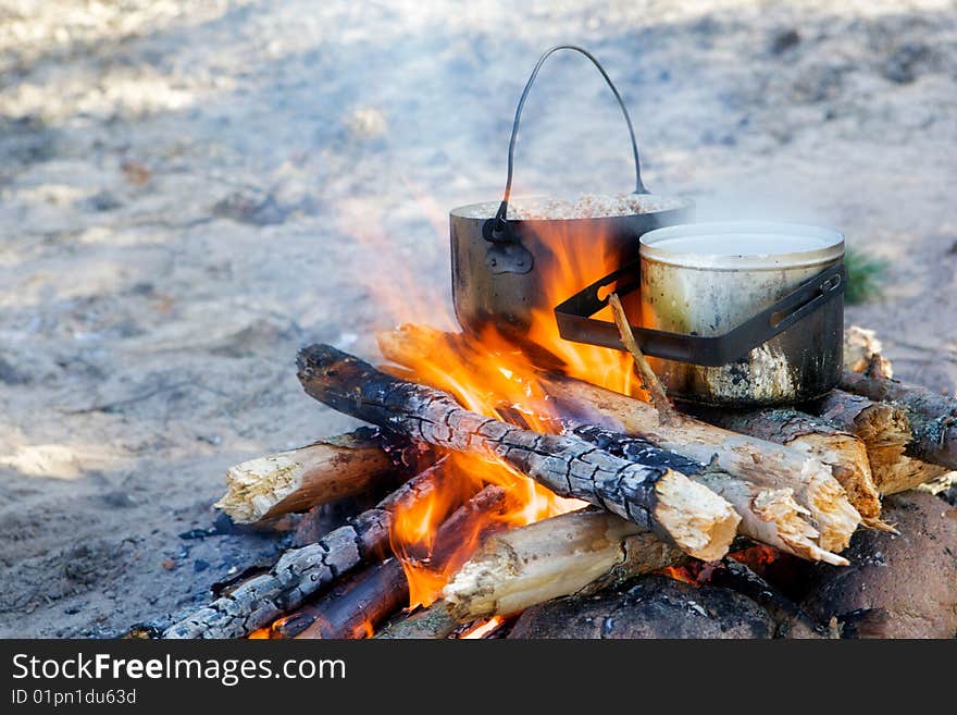 Cooking on a fire.