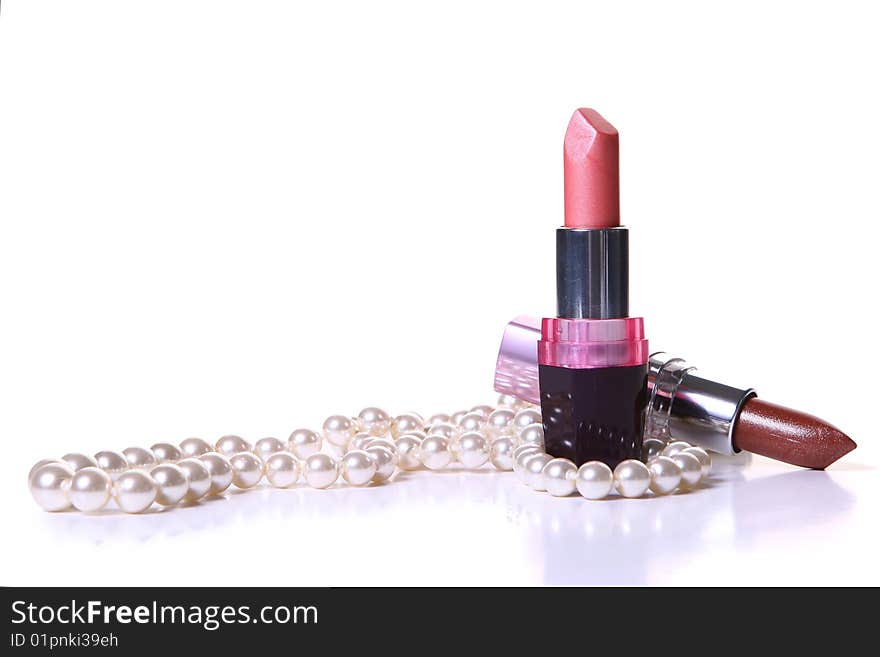 A red lipstick with perl on white