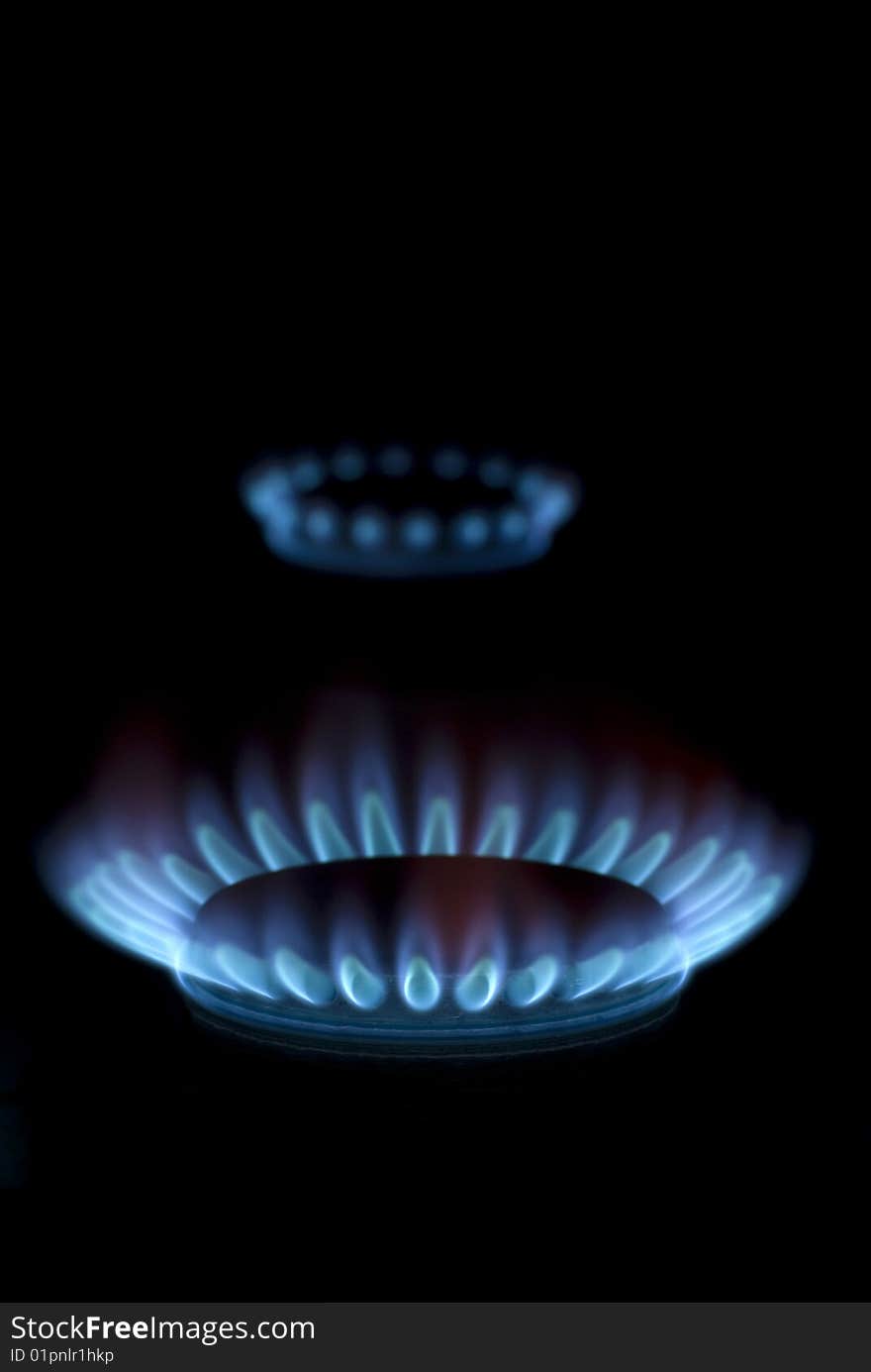 Blue flames of gas stove in the dark