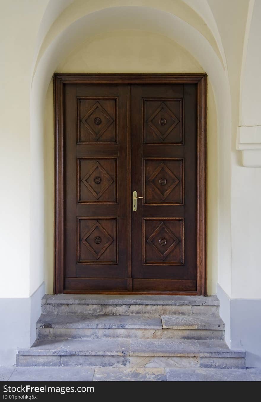 Beautiful panelled wood door with smooth plastered surround and stone steps. Beautiful panelled wood door with smooth plastered surround and stone steps