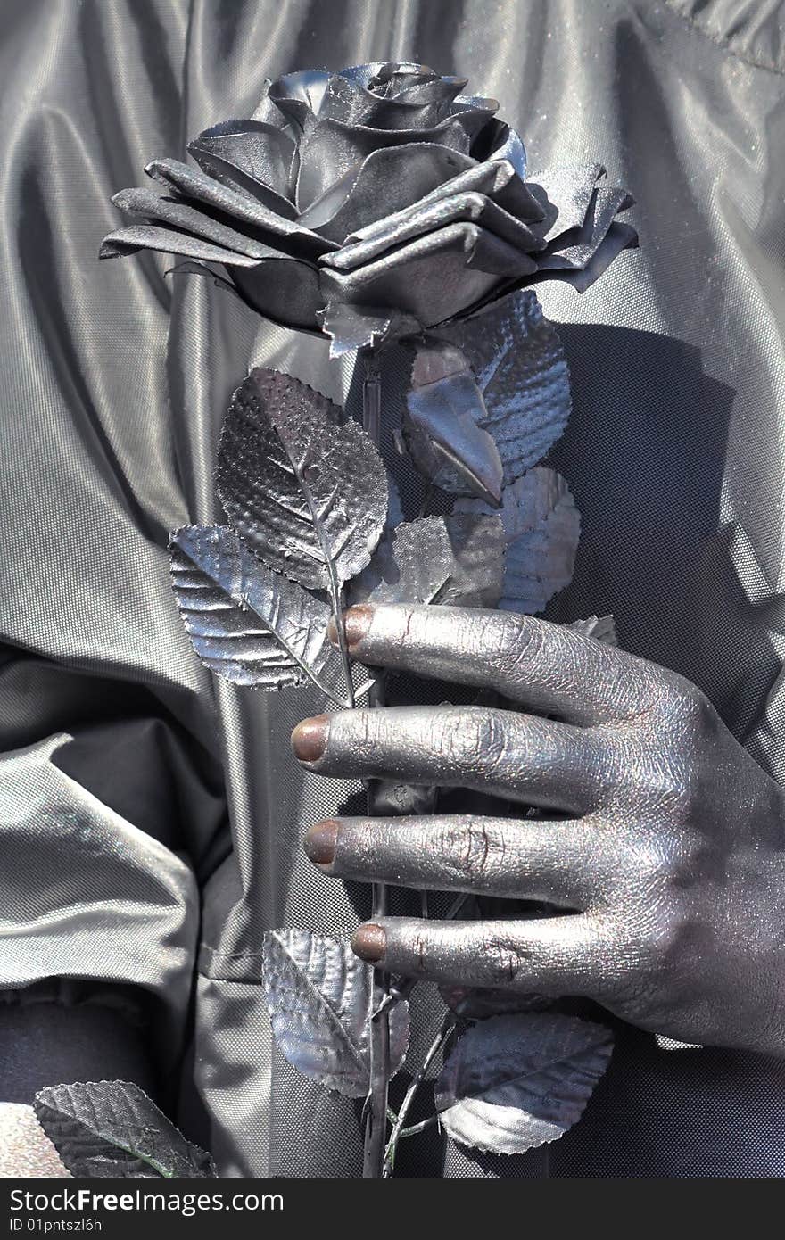 Silver girl holding a silver flower. Silver girl holding a silver flower