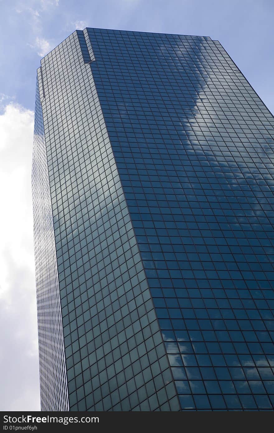 Urban view at modern glass building with reflection on blue sky. Urban view at modern glass building with reflection on blue sky